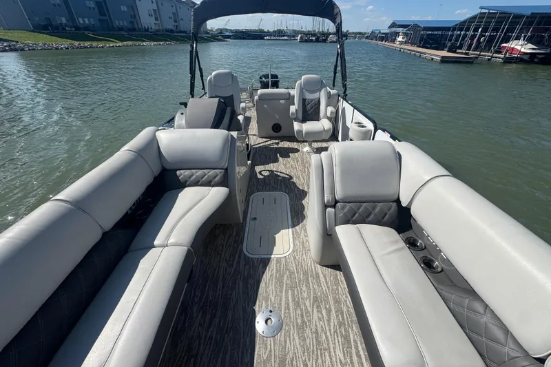 Slide: The Image of Luxury seating on 2020 SunCatcher Elite 326 DLX SS pontoon boat, docked on a sunny day. - 16