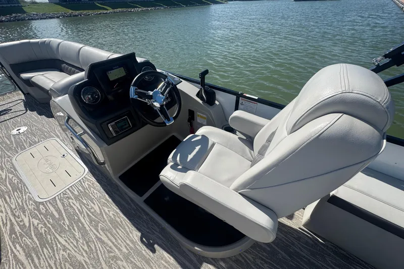 Slide: The Image of 2020 SunCatcher Elite 326 DLX SS boat interior with steering console and plush seating. - 21