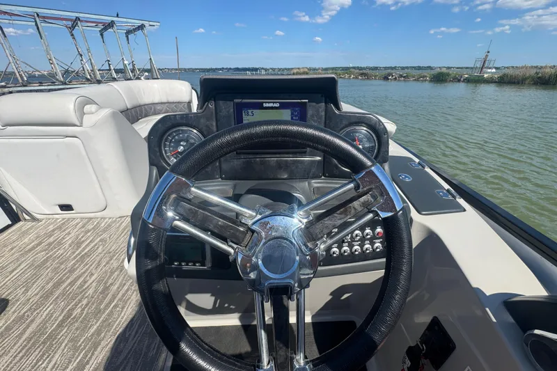 Slide: The Image of Steering wheel and dashboard of 2020 SunCatcher Elite 326 DLX SS boat on water. - 22