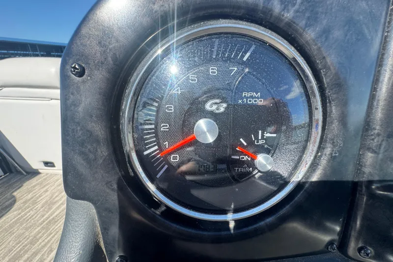 Slide: The Image of Close-up of a 2020 SunCatcher Elite 326 DLX SS tachometer displaying RPM and trim levels. - 23