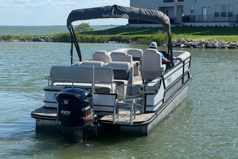 Slide: The Image of 2020 SunCatcher Elite 326 DLX SS pontoon boat on a lake with Yamaha motor. - 3