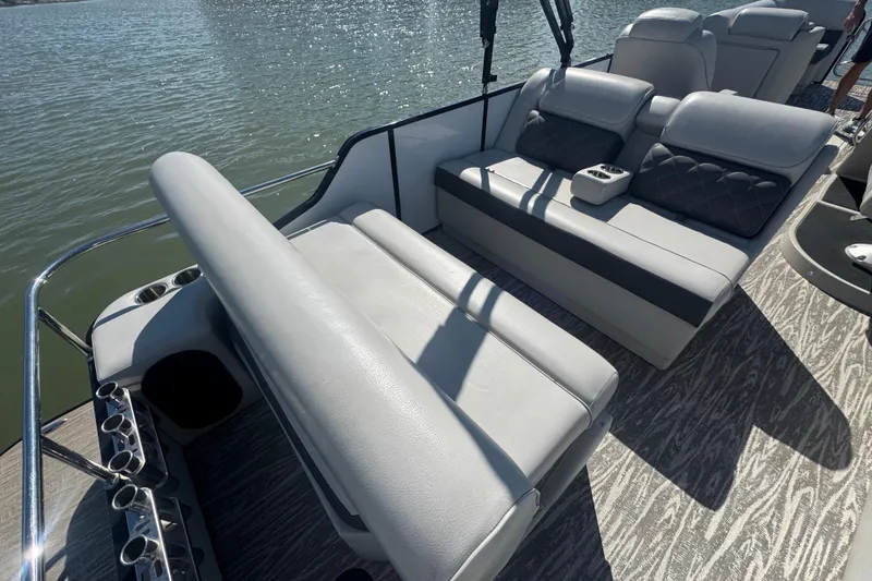 Slide: The Image of 2020 SunCatcher Elite 326 DLX SS boat interior with luxurious seating and cup holders. - 30