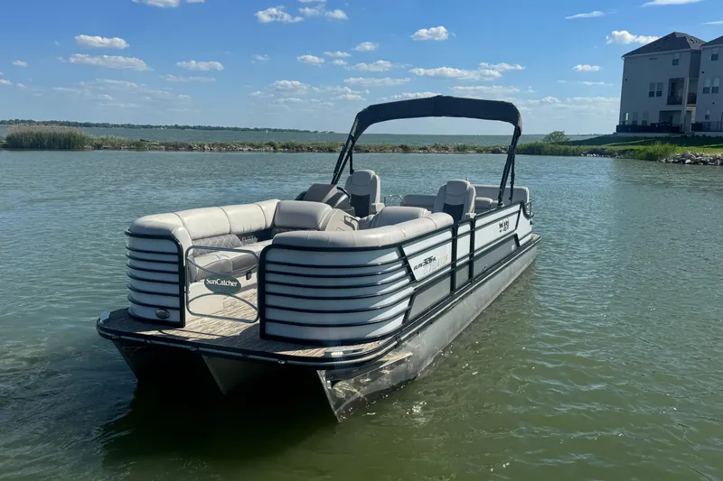 Slide: The Image of 2020 SunCatcher Elite 326 DLX SS pontoon boat on a calm lake. - 8