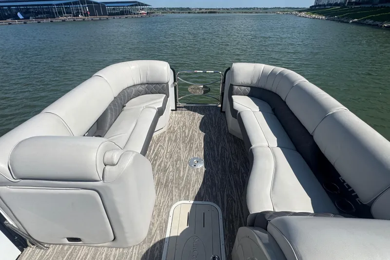 Slide: The Image of Luxurious seating on 2020 SunCatcher Elite 326 DLX SS pontoon boat, docked on a serene lake. - 9