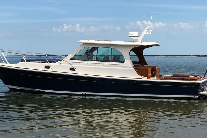 The Image of 2013 Hunt Yachts Harrier 36 in calm waters, showcasing sleek design and luxury features. - 0