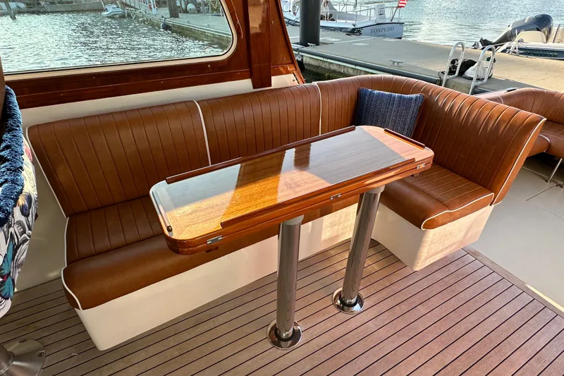 Slide: The Image of Luxurious 2013 Hunt Yachts Harrier 36 interior with elegant brown seating and wooden table. - 10