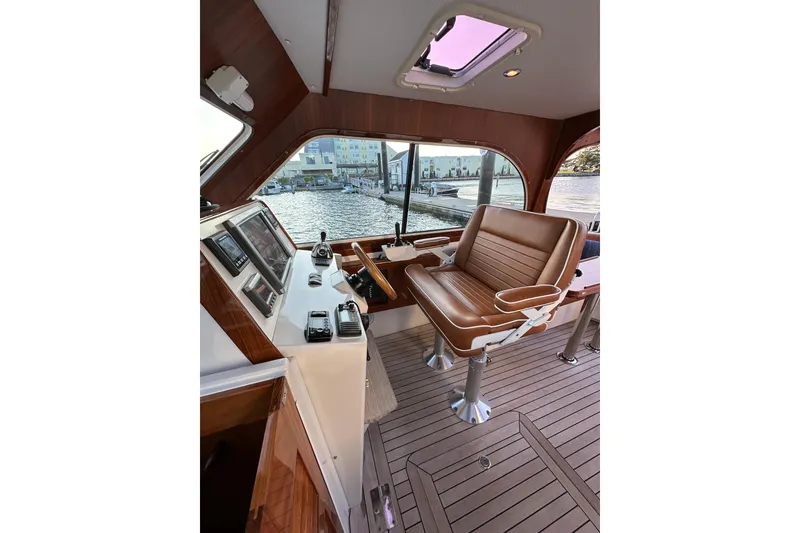 Slide: The Image of Interior of 2013 Hunt Yachts Harrier 36, featuring helm station and leather seating. - 12