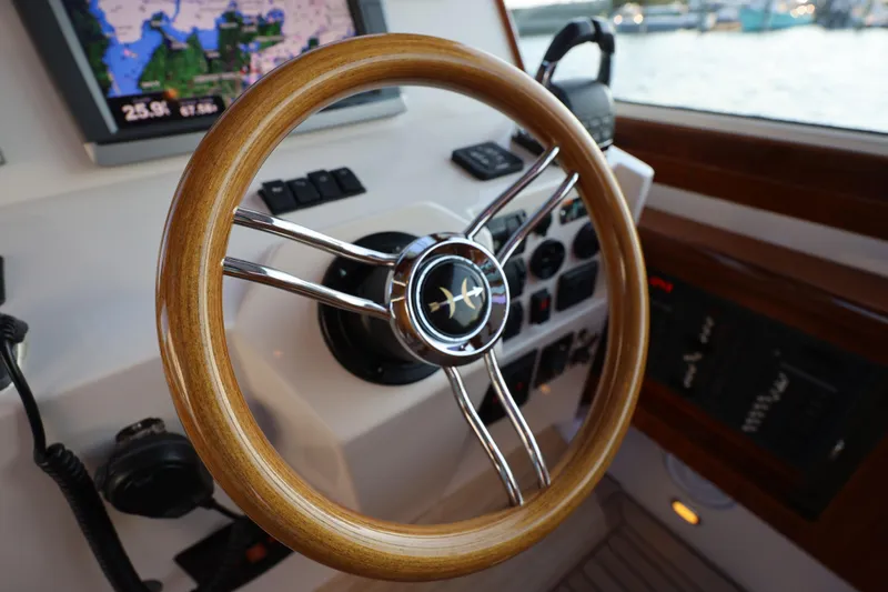 Slide: The Image of Steering wheel of 2013 Hunt Yachts Harrier 36, featuring navigation controls and display. - 14
