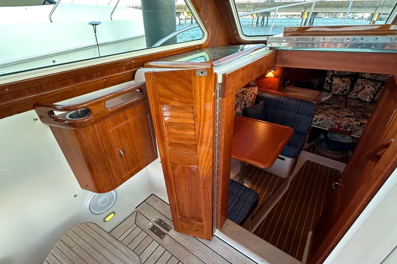 Slide: The Image of Interior view of 2013 Hunt Yachts Harrier 36, featuring wooden cabinetry and cozy seating area. - 20