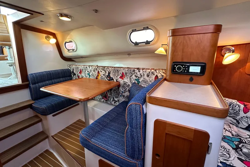 Slide: The Image of Interior of 2013 Hunt Yachts Harrier 36 with cozy seating and wooden accents. - 21