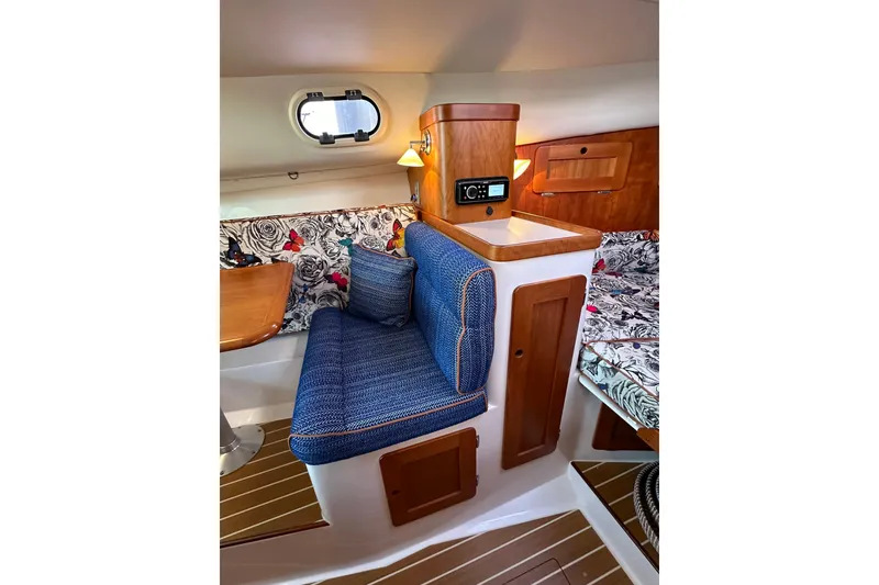 Slide: The Image of Interior of 2013 Hunt Yachts Harrier 36 with blue seating and floral decor. - 23