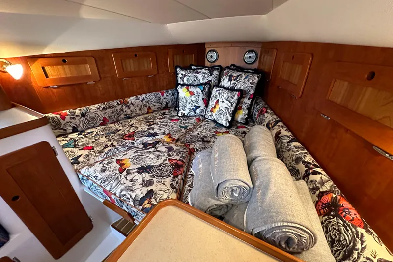 Slide: The Image of Luxurious cabin interior of 2013 Hunt Yachts Harrier 36 with floral bedding and wooden accents. - 25