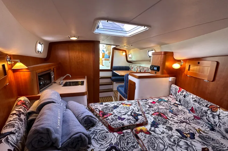 Slide: The Image of Luxurious 2013 Hunt Yachts Harrier 36 cabin interior with floral bedding and wooden finishes. - 26