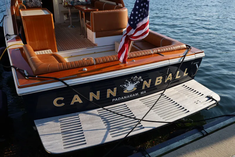 Slide: The Image of 2013 Hunt Yachts Harrier 36 named "Cannonball" docked, featuring elegant seating and American flag. - 3