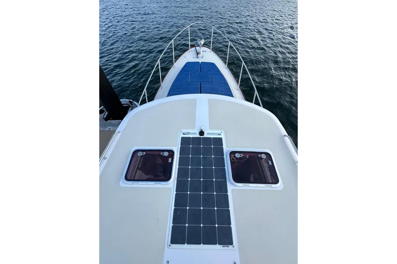 Slide: The Image of 2013 Hunt Yachts Harrier 36 boat deck with solar panels, overlooking calm water. - 31