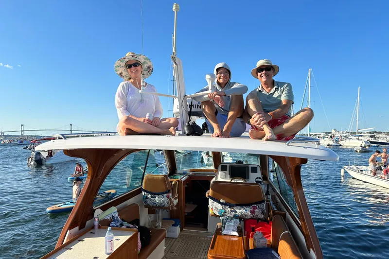 Slide: The Image of Three people relaxing on a 2013 Hunt Yachts Harrier 36 in a sunny marina. - 33