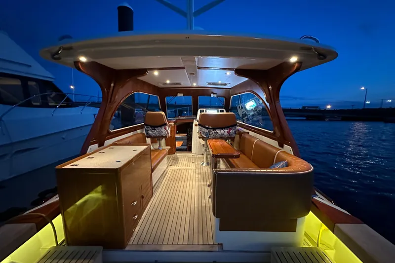 Slide: The Image of Luxurious 2013 Hunt Yachts Harrier 36 interior at dusk, featuring elegant seating and ambient lighting. - 34
