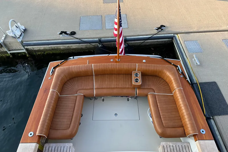 Slide: The Image of 2013 Hunt Yachts Harrier 36 with brown leather seating at dock. - 4