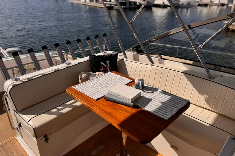 Slide: The Image of Cozy seating area on 1999 Grand Banks 38 Eastbay EX yacht with table and decor. - 11