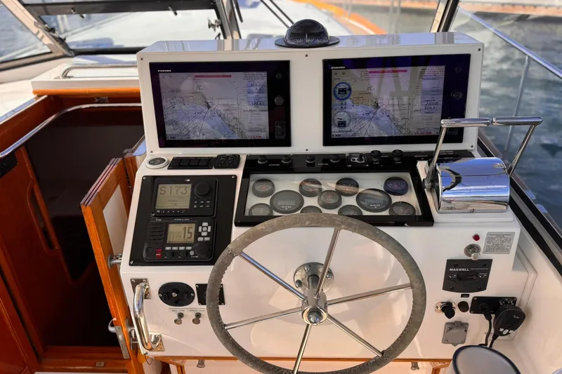 Slide: The Image of Helm of 1999 Grand Banks 38 Eastbay EX with navigation screens and controls. - 15