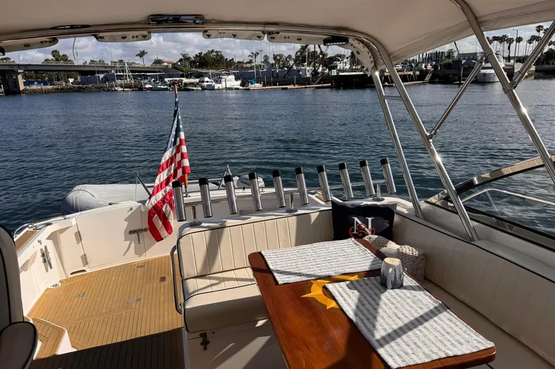 Slide: The Image of 1999 Grand Banks 38 Eastbay EX yacht interior with American flag and waterfront view. - 16