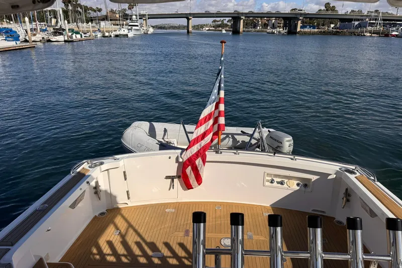 Slide: The Image of 1999 Grand Banks 38 Eastbay EX yacht with American flag, docked in a marina. - 17