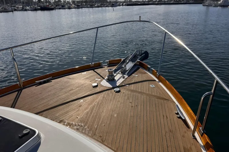 Slide: The Image of Bow of 1999 Grand Banks 38 Eastbay EX yacht on calm water. - 19