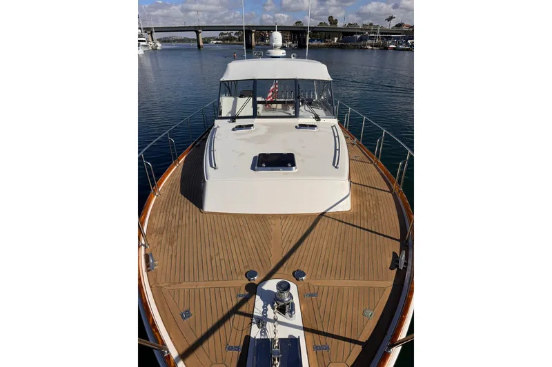 Slide: The Image of 1999 Grand Banks 38 Eastbay EX yacht with teak deck, docked in a marina. - 20
