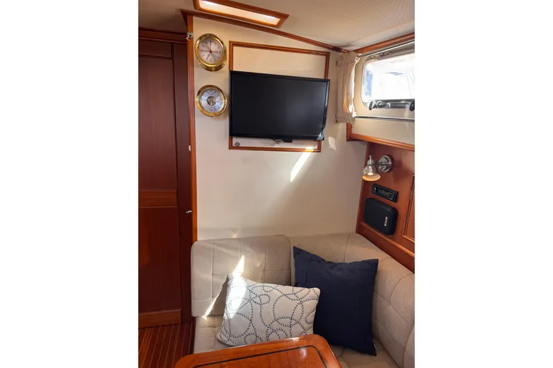 Slide: The Image of Interior of 1999 Grand Banks 38 Eastbay EX with TV, seating, and nautical decor. - 24