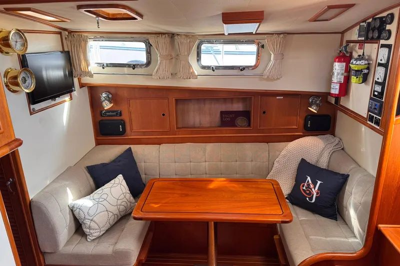 Slide: The Image of Cozy interior of 1999 Grand Banks 38 Eastbay EX with seating and wooden table. - 3