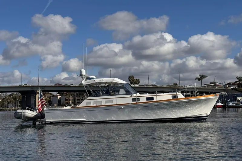 Slide: The Image of 1999 Grand Banks 38 Eastbay EX yacht on calm water under cloudy sky. - 5