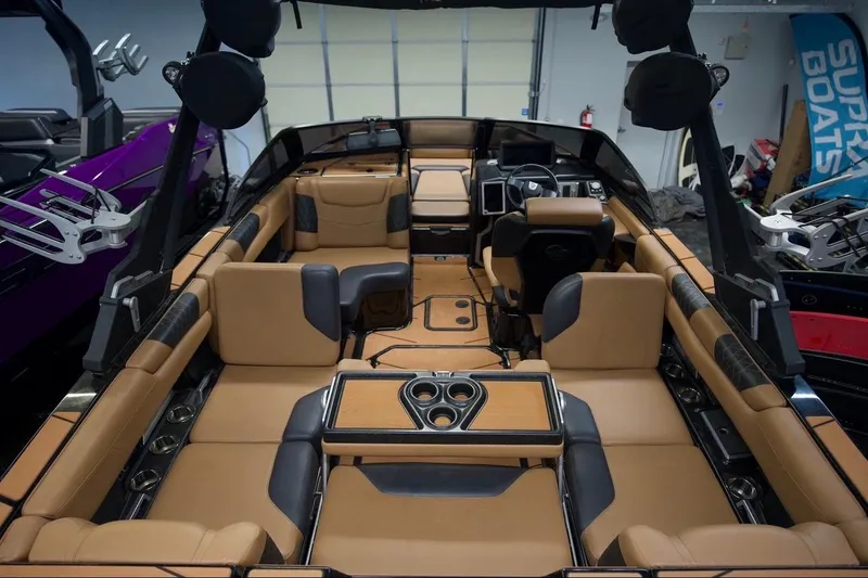 Slide: The Image of Luxurious interior of a 2021 Malibu M220 boat with tan and black seating. - 10