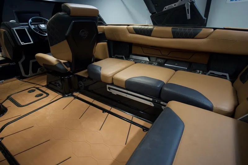 Slide: The Image of 2021 Malibu M220 interior with luxurious tan and black leather seating. - 12