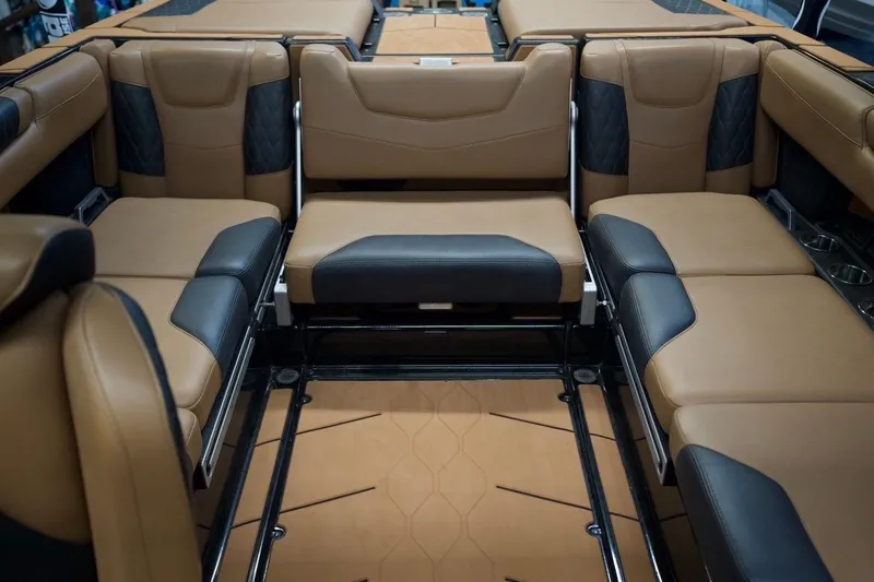 Slide: The Image of Luxurious interior seating of 2021 Malibu M220 boat, featuring tan and black upholstery. - 13