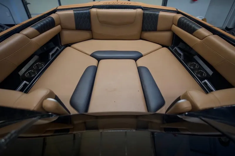 Slide: The Image of Luxurious interior of 2021 Malibu M220 boat with tan and black seating. - 15
