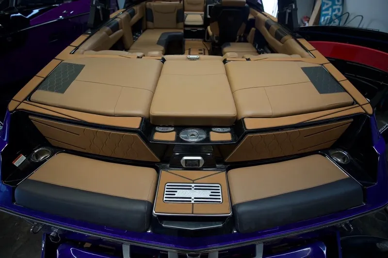 Slide: The Image of 2021 Malibu M220 boat interior with tan leather seating and modern design elements. - 9