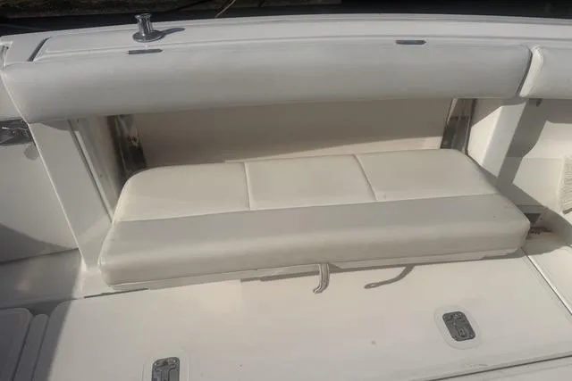 Slide: The Image of 2001 Tiara Yachts 2900 Open boat seating area with white cushioned bench. - 12