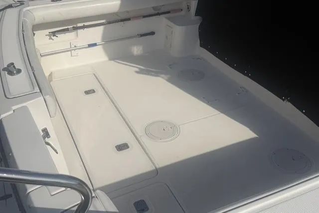 Slide: The Image of 2001 Tiara Yachts 2900 Open boat deck with storage compartments and fishing rod holder. - 14