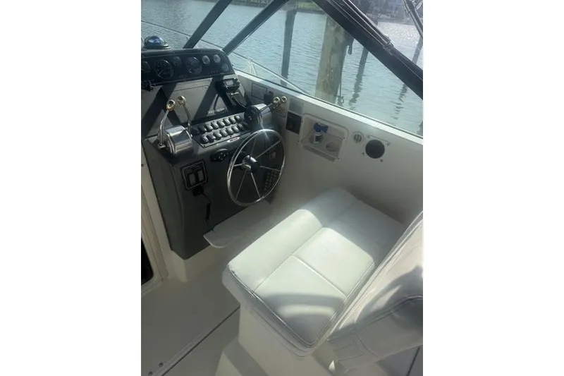 Slide: The Image of Helm of 2001 Tiara Yachts 2900 Open with steering wheel and controls. - 18