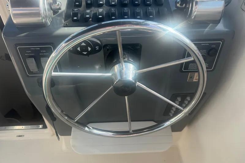 Slide: The Image of Steering wheel and controls of a 2001 Tiara Yachts 2900 Open boat. - 19