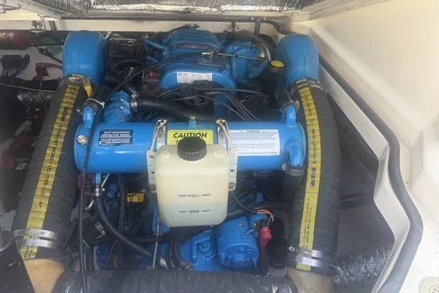 Slide: The Image of Engine compartment of a 2001 Tiara Yachts 2900 Open, featuring a blue marine engine. - 26