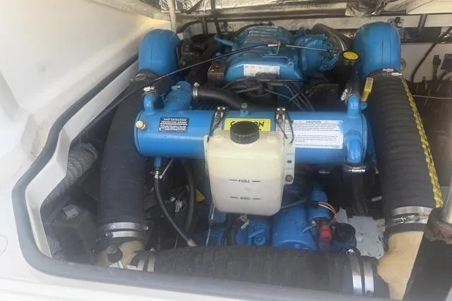 Slide: The Image of Engine compartment of a 2001 Tiara Yachts 2900 Open, showcasing blue marine engine components. - 27