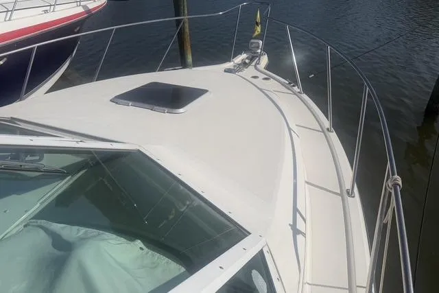 Slide: The Image of 2001 Tiara Yachts 2900 Open boat deck with railing, docked in calm waters. - 30