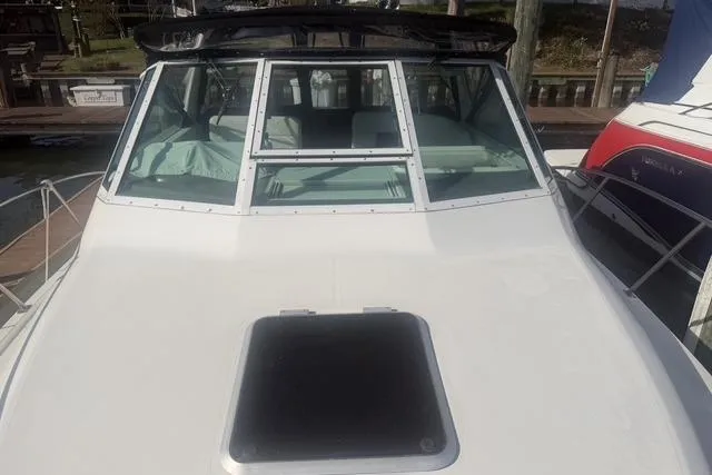 Slide: The Image of 2001 Tiara Yachts 2900 Open boat with white deck and windshield, docked at marina. - 31