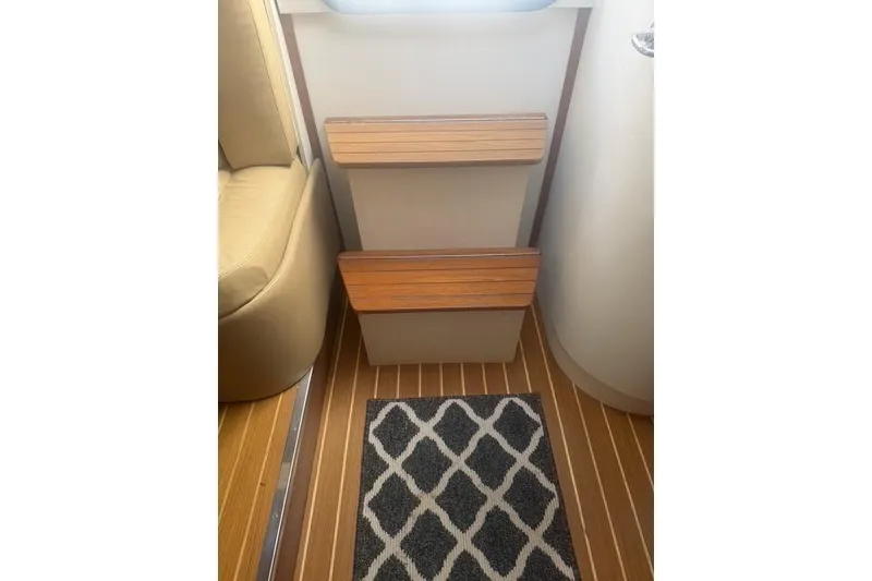 Slide: The Image of Interior of 2001 Tiara Yachts 2900 Open with wooden steps and patterned rug. - 33