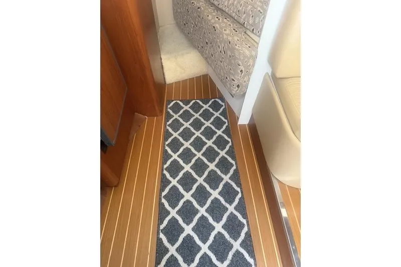 Slide: The Image of Interior of 2001 Tiara Yachts 2900 Open with patterned rug and wooden flooring. - 34