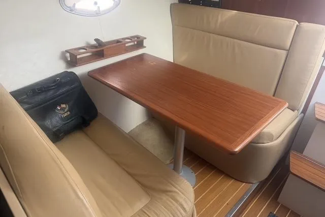 Slide: The Image of Interior of 2001 Tiara Yachts 2900 Open with wooden table and beige seating. - 36