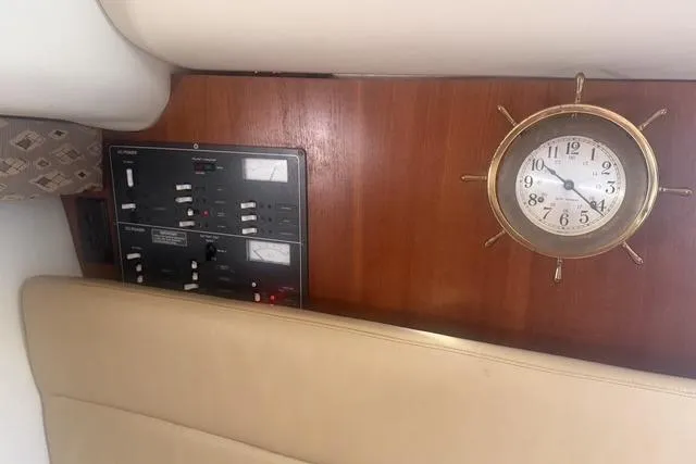 Slide: The Image of 2001 Tiara Yachts 2900 Open interior with control panel and nautical clock. - 37