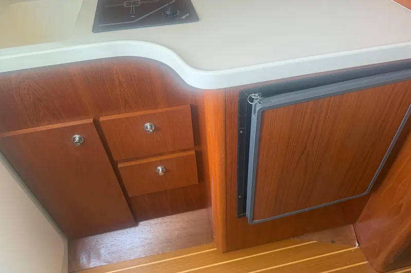 Slide: The Image of Wooden cabinetry and countertop in a 2001 Tiara Yachts 2900 Open boat interior. - 39
