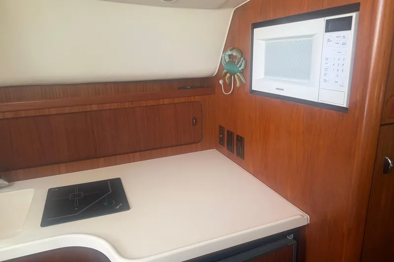 Slide: The Image of 2001 Tiara Yachts 2900 Open galley with microwave and cooktop. - 40